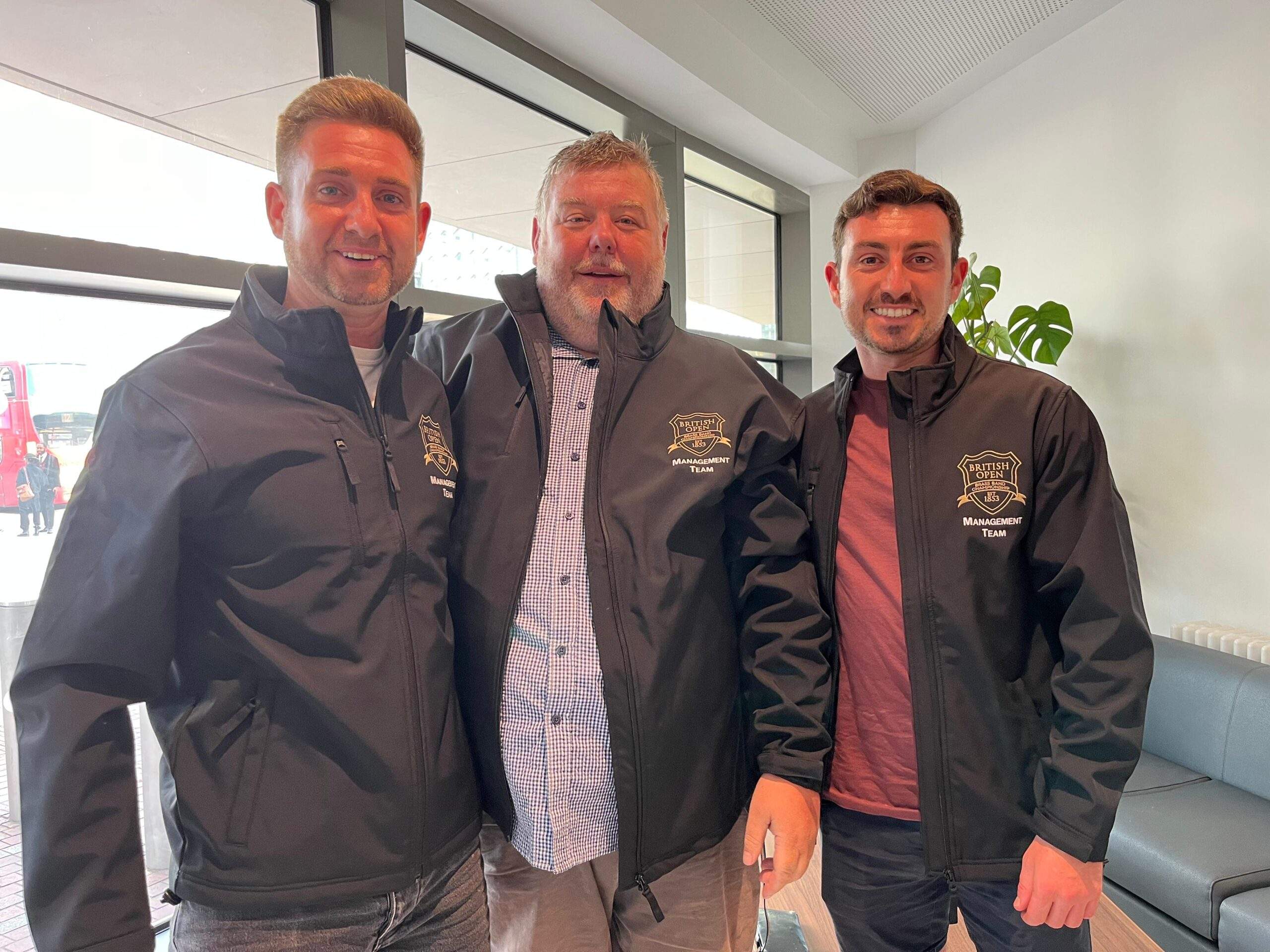 Event management team at the British Open Brass Band Championships wearing embroidered softshell jackets with the official event logo, highlighting professional branded uniforms.